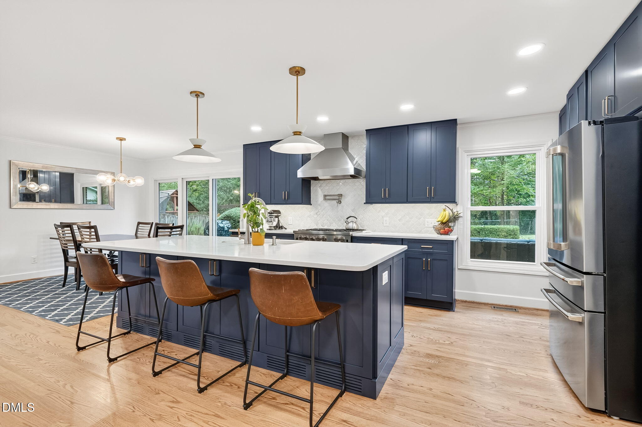 4206 Laurel Ridge Drive Raleigh, NC 27612 - Photo 16 of 62 a kitchen with a dining table chairs sink and cabinets