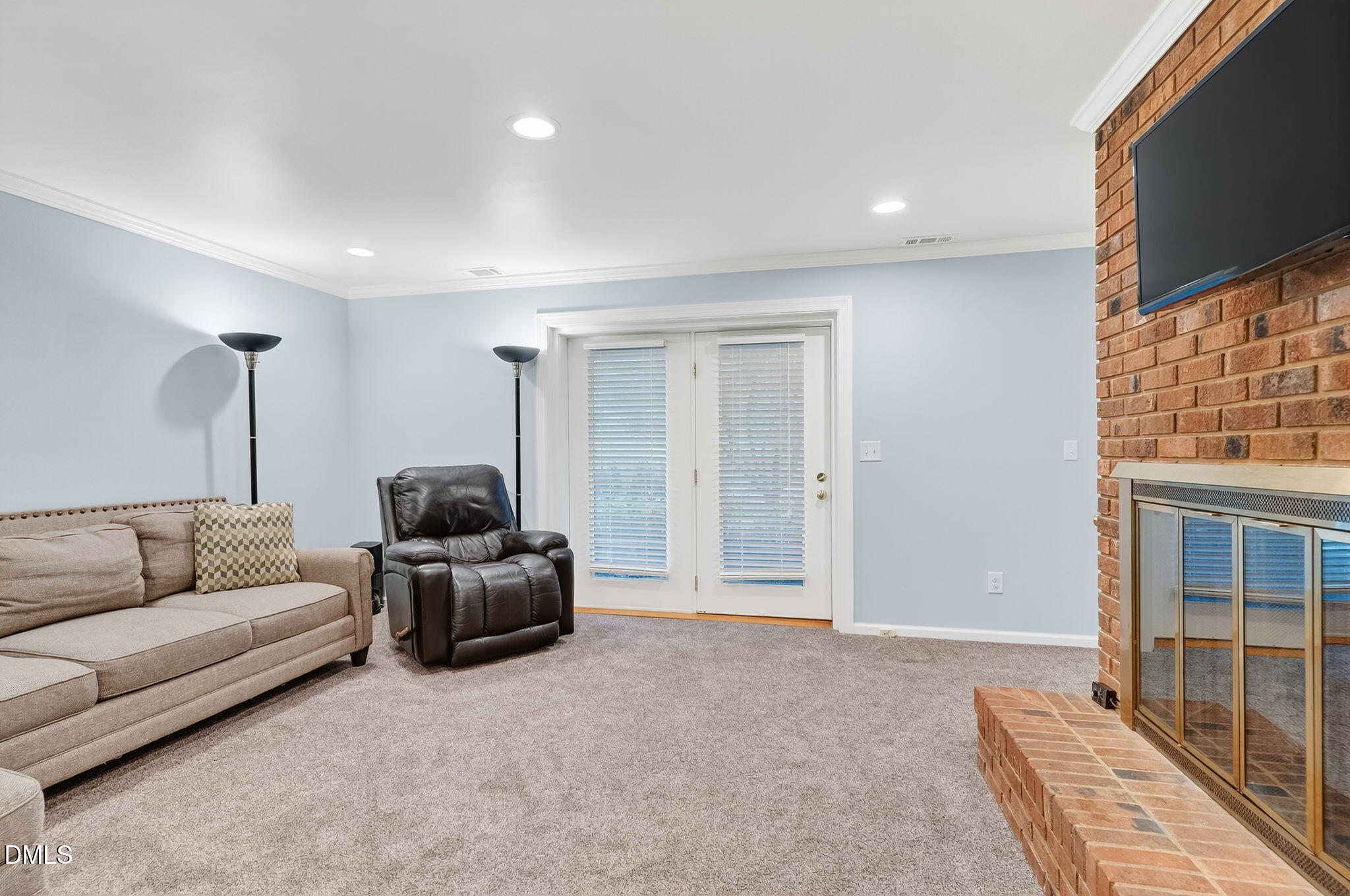 4206 Laurel Ridge Drive Raleigh, NC 27612 - Photo 19 of 62 a living room with furniture and a flat screen tv