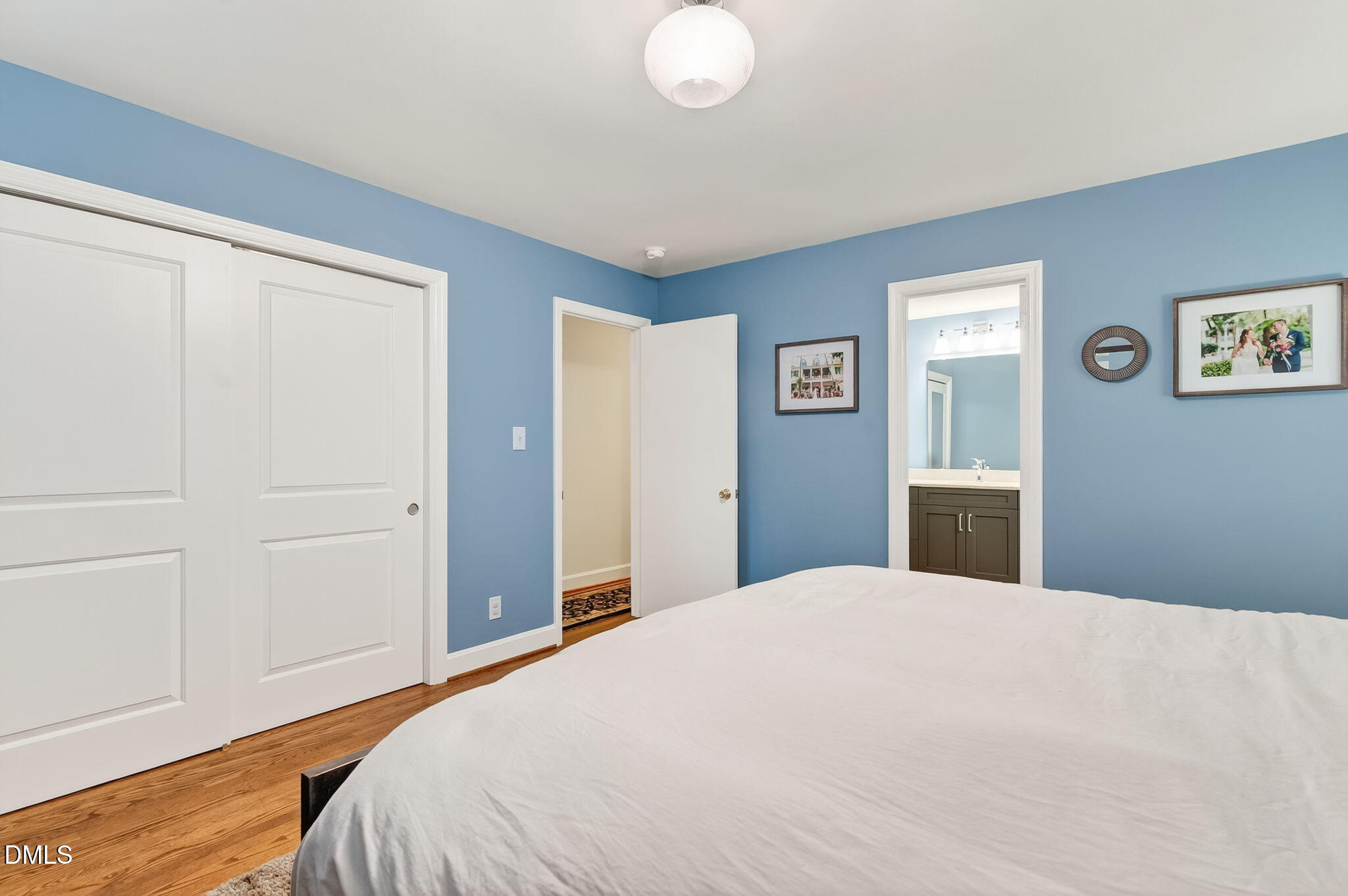 4206 Laurel Ridge Drive Raleigh, NC 27612 - Photo 22 of 62 a bedroom with a large bed and a chandelier