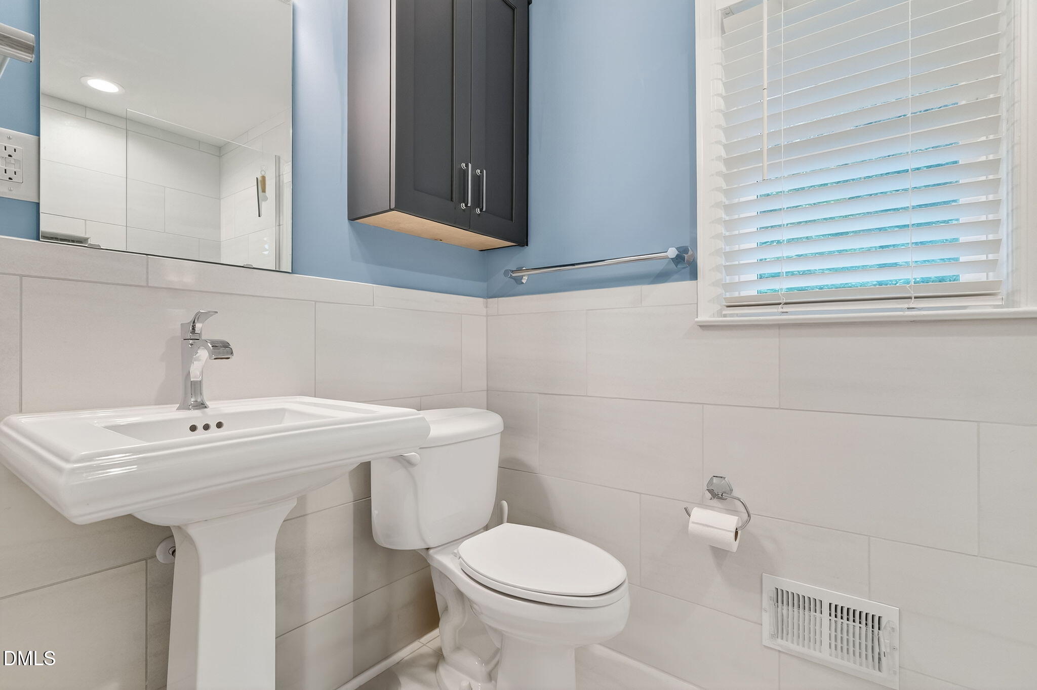 4206 Laurel Ridge Drive Raleigh, NC 27612 - Photo 23 of 62 a bathroom with a sink a toilet and a mirror