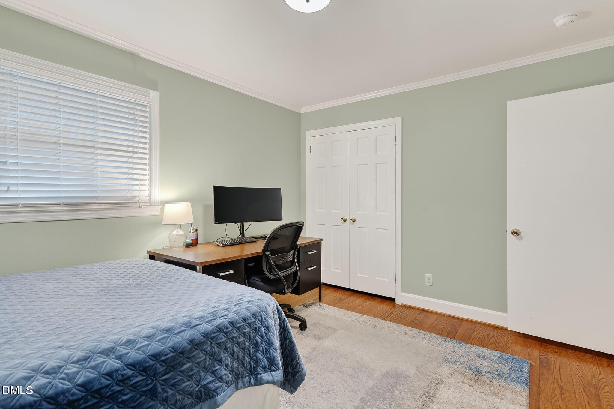 4206 Laurel Ridge Drive Raleigh, NC 27612 - Photo 30 of 62 a bedroom with a bed and wooden floor