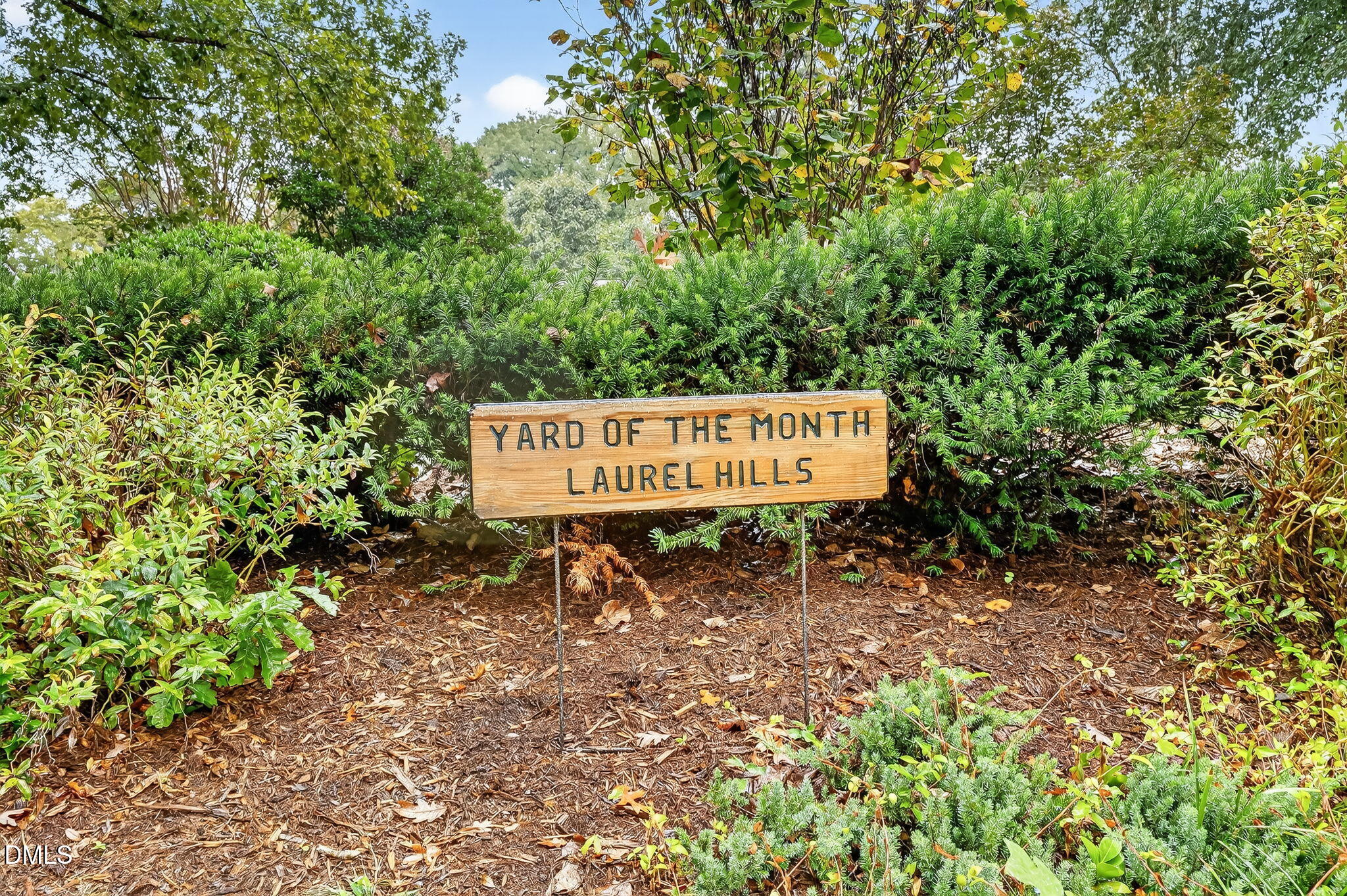 4206 Laurel Ridge Drive Raleigh, NC 27612 - Photo 52 of 62 a sign board with a bench and trees