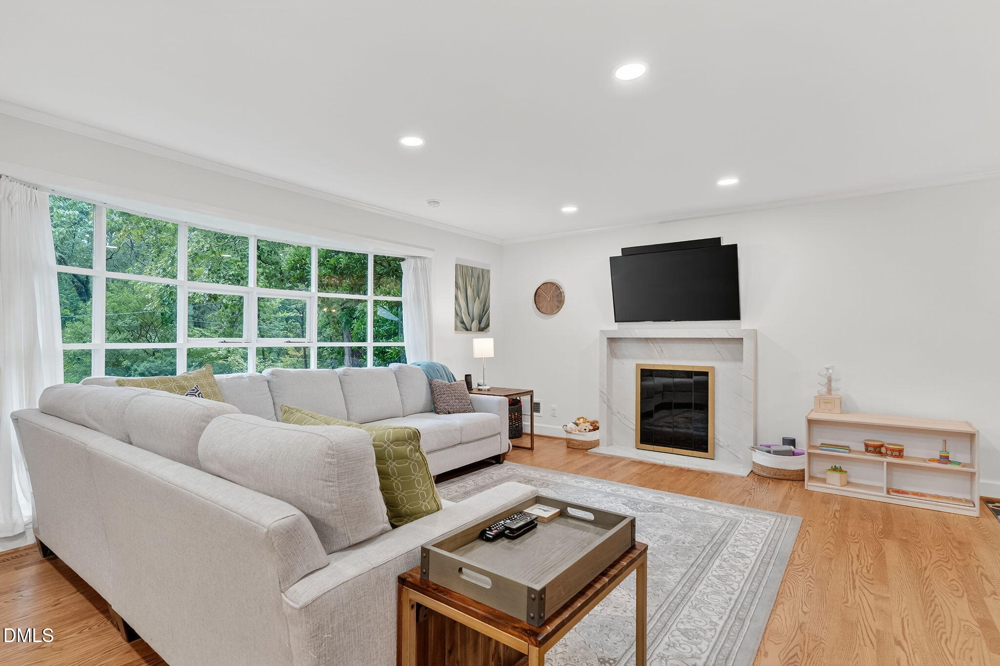 4206 Laurel Ridge Drive Raleigh, NC 27612 - Photo 7 of 62 a living room with furniture a flat screen tv and a fireplace