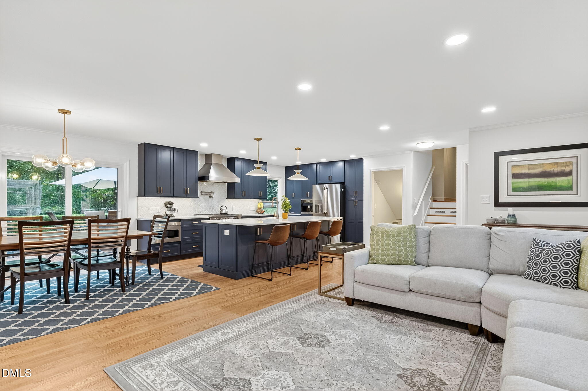 4206 Laurel Ridge Drive Raleigh, NC 27612 - Photo 9 of 62 a living room with furniture a kitchen view and a large window
