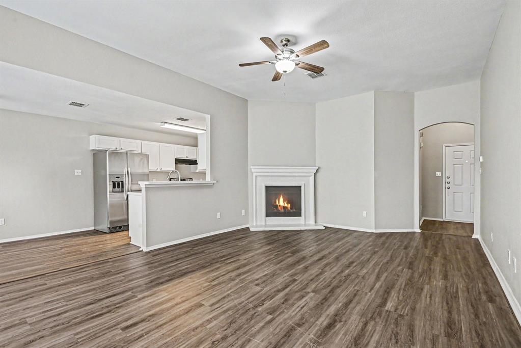 138 Kings Way Drive Rhome, TX 76078 - Photo 3 of 16 a view of empty room with wooden floor and fireplace