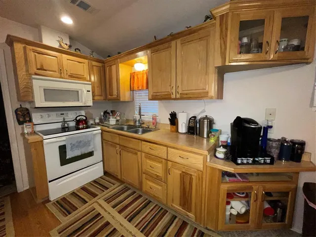 a view of a kitchen with dining table and chairs