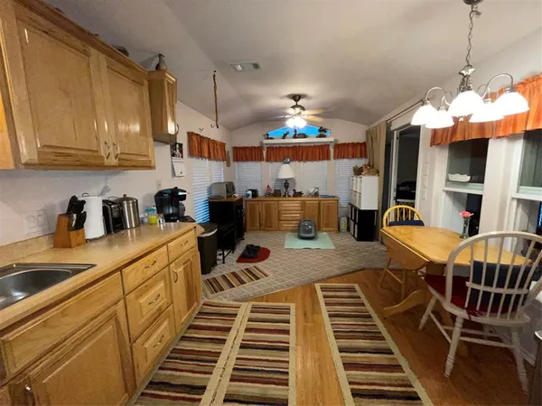 a kitchen with stainless steel appliances a sink stove and cabinets