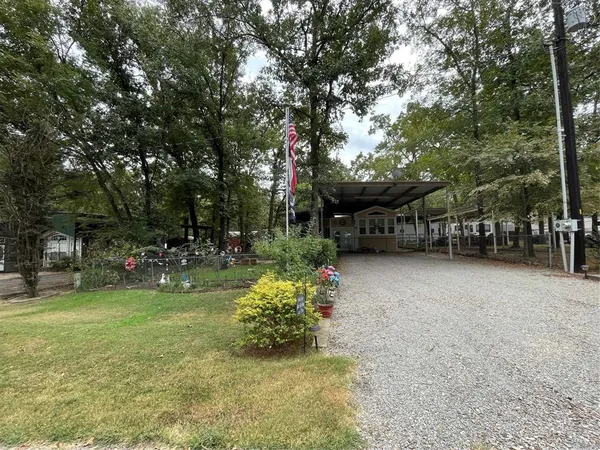 a view of a house with backyard and sitting area