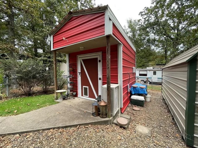 a view of a backyard with wooden fence