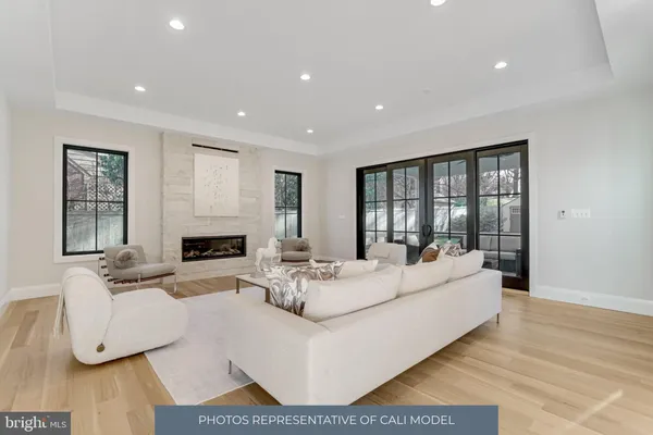 a living room with fireplace furniture and a wooden floor