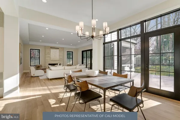a view of a dining room with furniture large windows and wooden floor