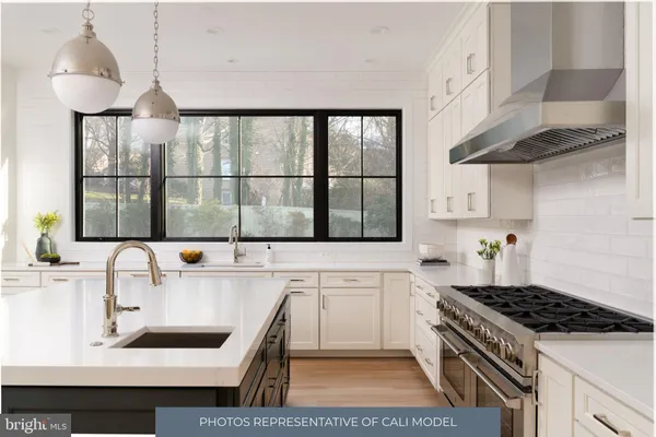 a kitchen with stainless steel appliances granite countertop a sink stove and cabinets