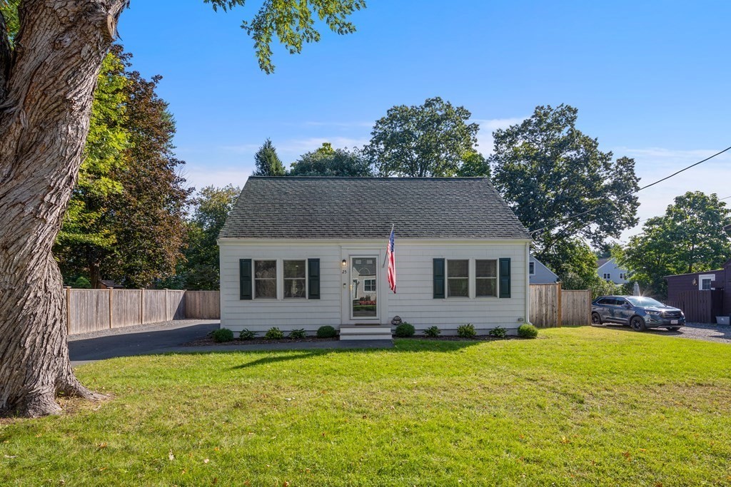 25 Eames Street North Reading, MA 01864 - Photo 1 of 25 a front view of house with yard and trees in the background