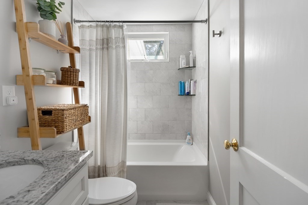 25 Eames Street North Reading, MA 01864 - Photo 11 of 25 a bathroom with a granite countertop bathtub shower sink vanity and toilet