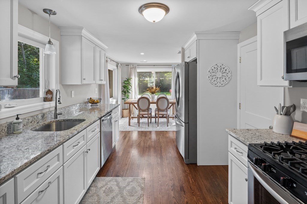 25 Eames Street North Reading, MA 01864 - Photo 6 of 25 a kitchen with granite countertop a stove top oven sink and cabinets