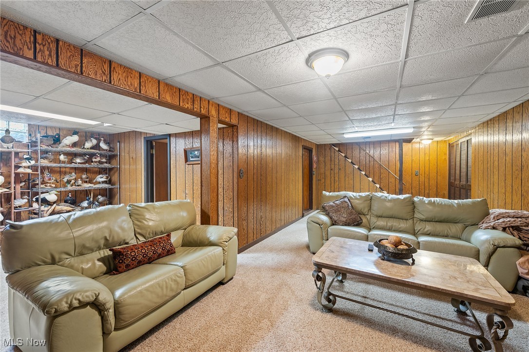 3314 Decamp Road Youngstown, OH 44511 - Photo 29 of 31 Carpeted living room featuring a drop ceiling and wooden walls
