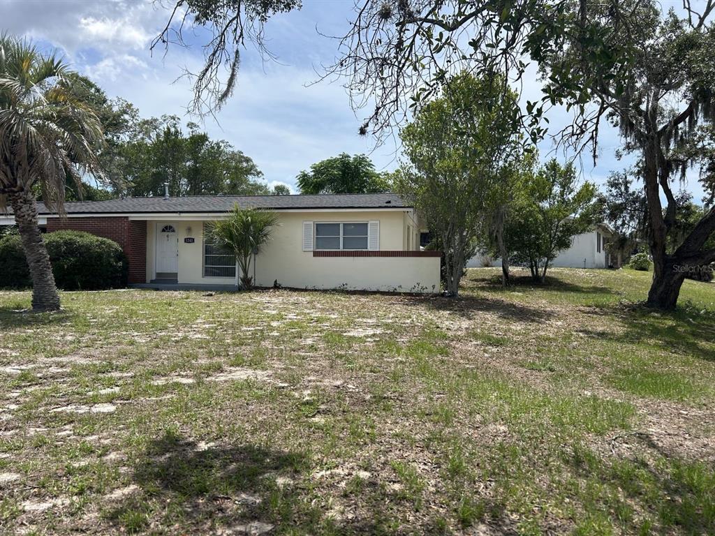 1241 Pilgrim Road Spring Hill, FL 34606 - Photo 26 of 28 front view of a house with a yard