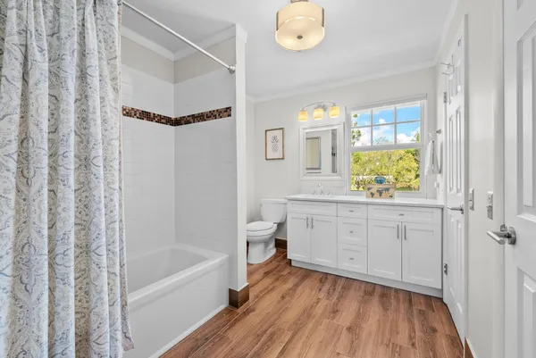 a bathroom with a granite countertop sink a toilet and bathtub