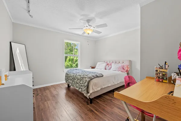 a bedroom with two beds and a chandelier