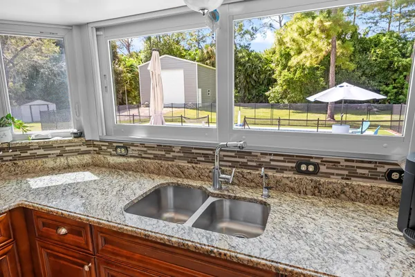 a kitchen with a sink and a large window