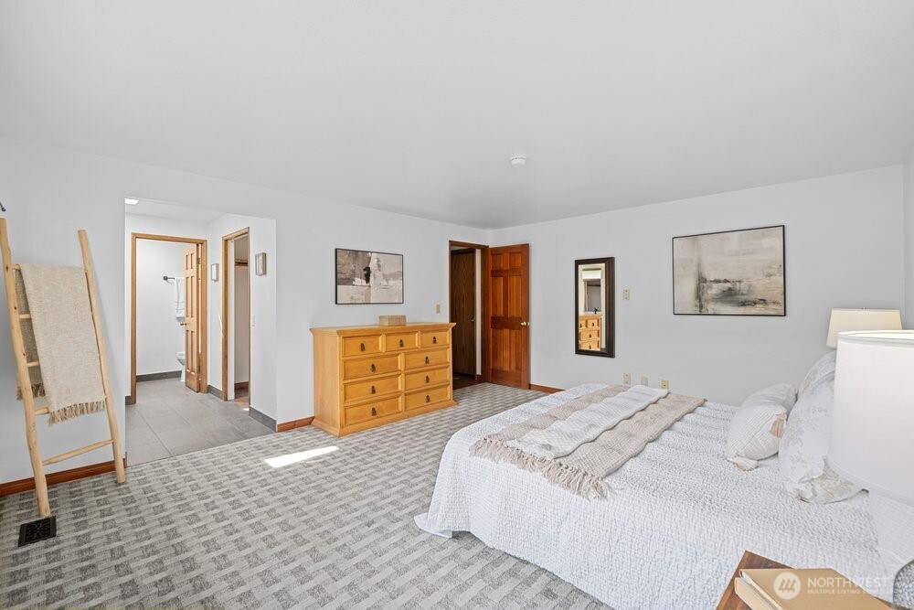 902 7th Avenue South Edmonds, WA 98020 - Photo 16 of 31 a bedroom with a large bed and a couch