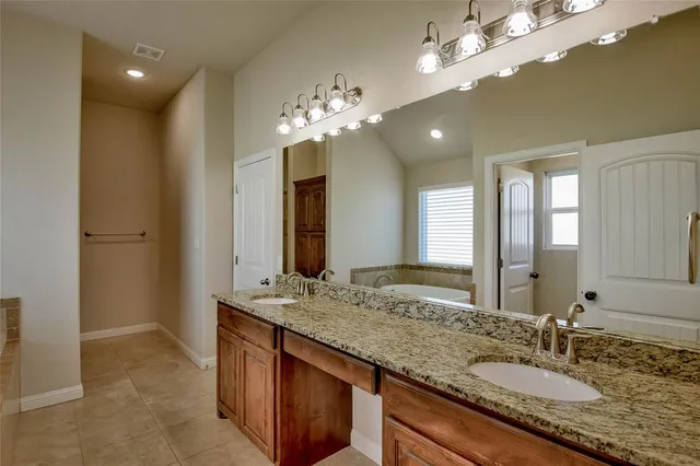 a bathroom with a granite countertop sink a large mirror and a shower