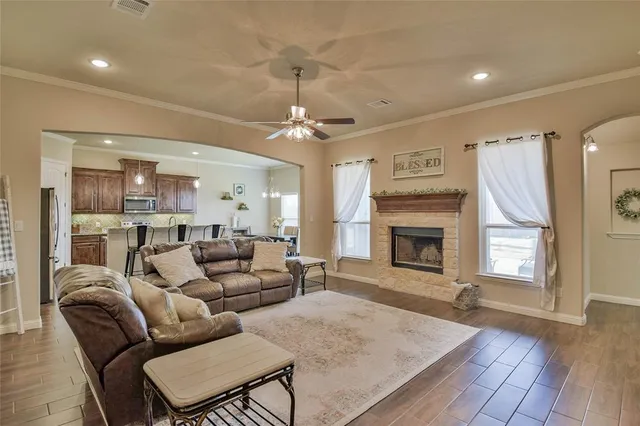 a living room with furniture a fireplace and a chandelier