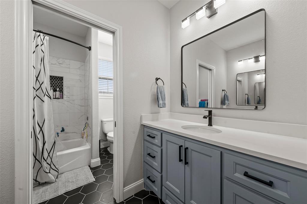820 Forward Pass Drive Hewitt, TX 76643 - Photo 10 of 22 a bathroom with a granite countertop sink a mirror and a shower