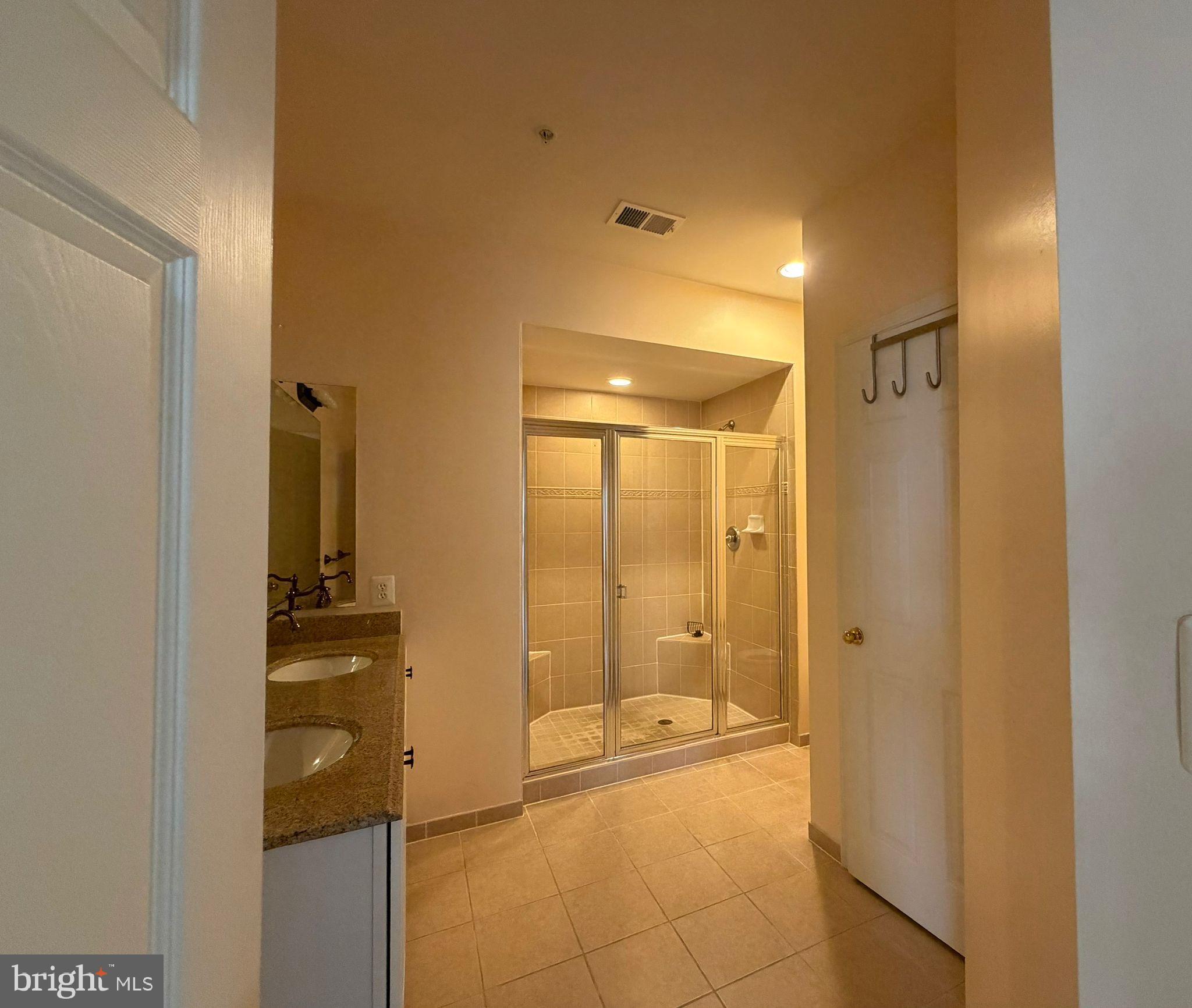 7248 Elkridge Crossing Way Elkridge, MD 21075 - Photo 30 of 47 a bathroom with a glass shower door