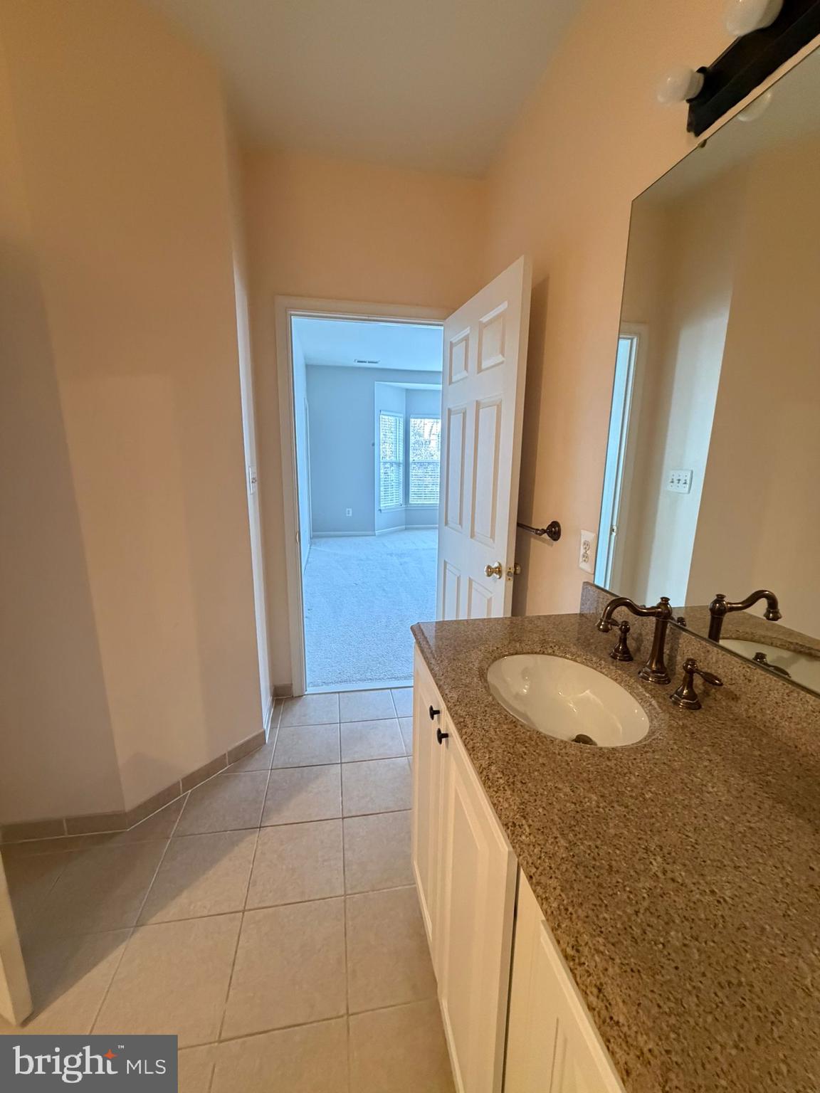 7248 Elkridge Crossing Way Elkridge, MD 21075 - Photo 31 of 47 a bathroom with a granite countertop sink and a mirror