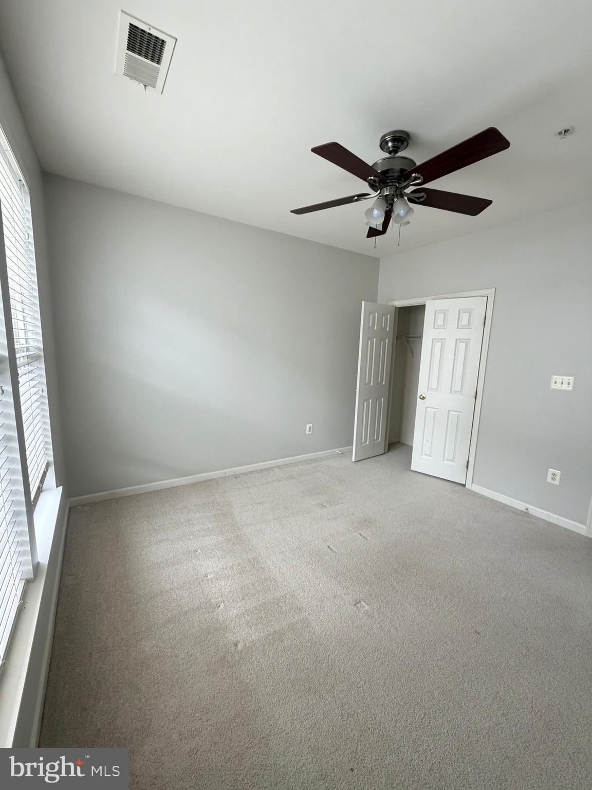 7248 Elkridge Crossing Way Elkridge, MD 21075 - Photo 36 of 47 en empty room with windows and ceiling fan