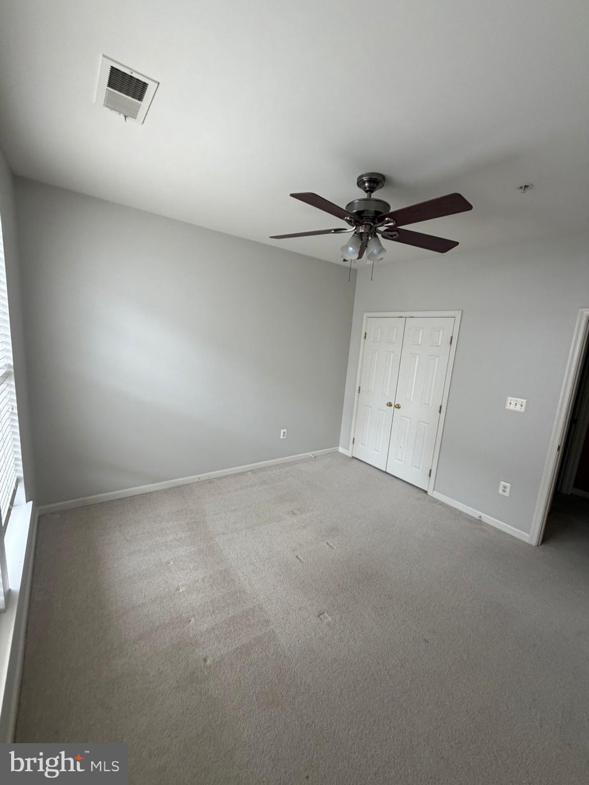7248 Elkridge Crossing Way Elkridge, MD 21075 - Photo 47 of 47 an empty room with a ceiling fan and a window