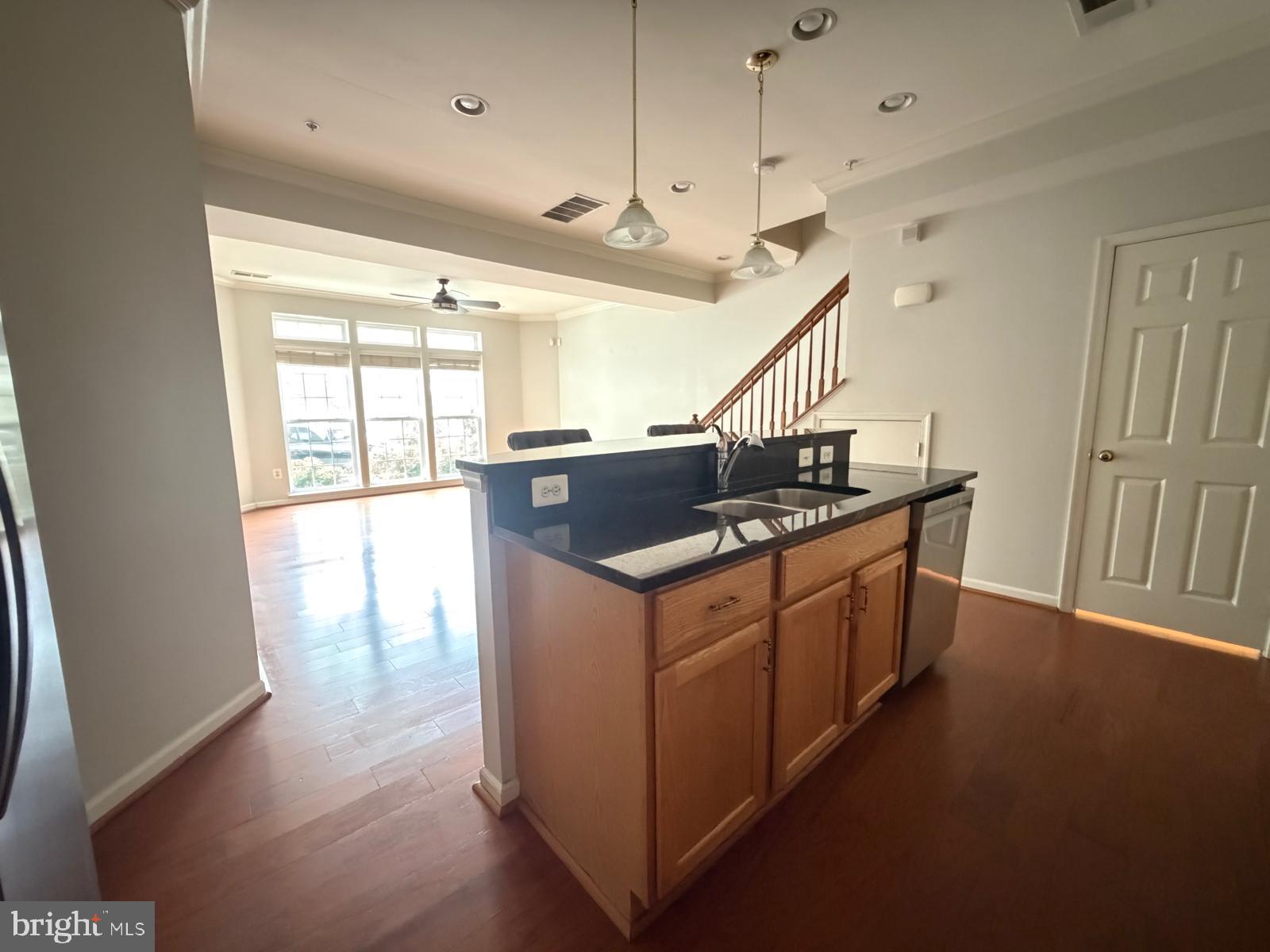 7248 Elkridge Crossing Way Elkridge, MD 21075 - Photo 9 of 47 a kitchen with granite countertop a sink and a stove top oven