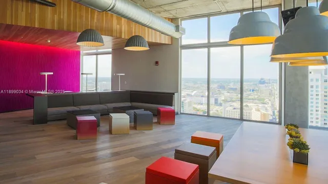 a living room with furniture and a floor to ceiling window