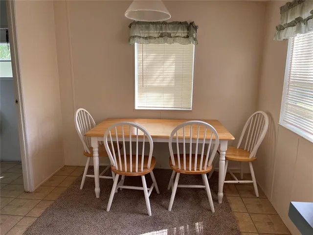 a view of a dining room with furniture and window