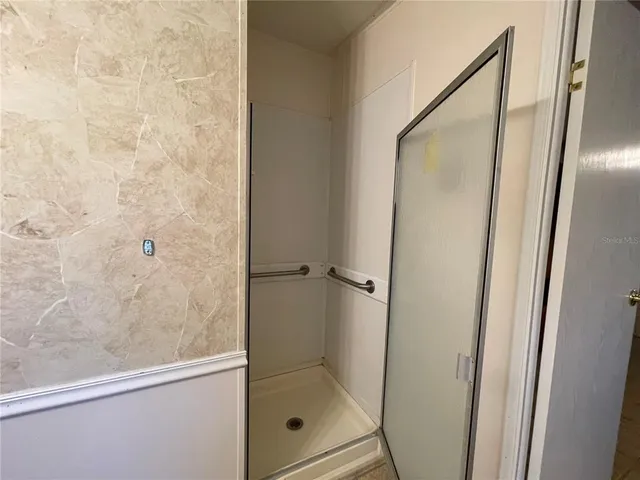 a bedroom with a bed and a mirror