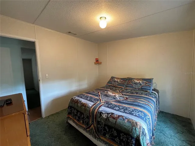 a view of a patio with two couches and deck with wooden floor and fence and floor to ceiling window