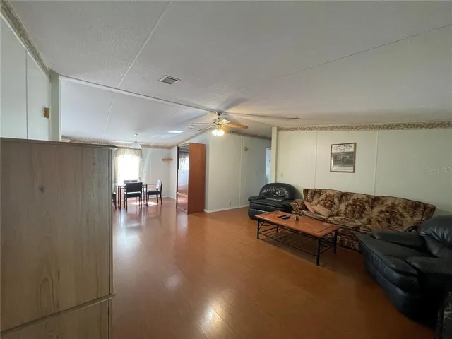 a living room with furniture and pool table