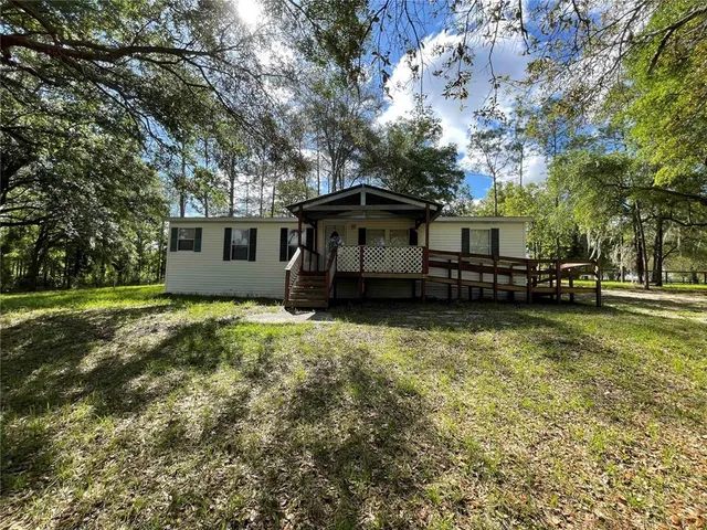 a view of a yard with large trees