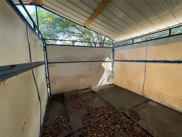 a view of dirt yard with a large tree