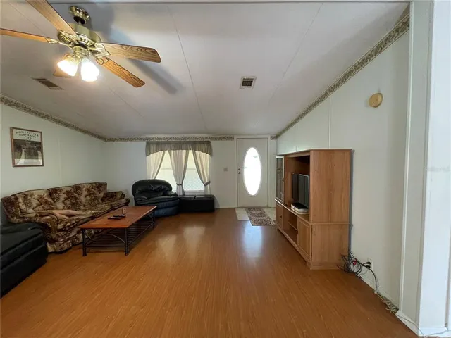 a kitchen with granite countertop a refrigerator and a sink