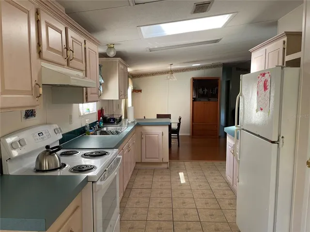 a kitchen with lots of counter top space and windows