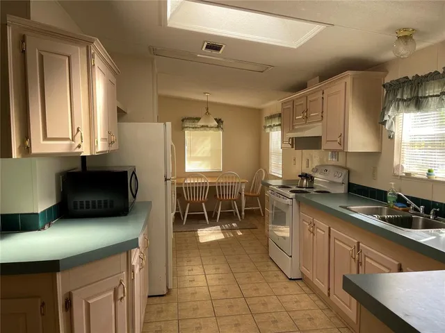 a kitchen with stainless steel appliances granite countertop a sink and cabinets