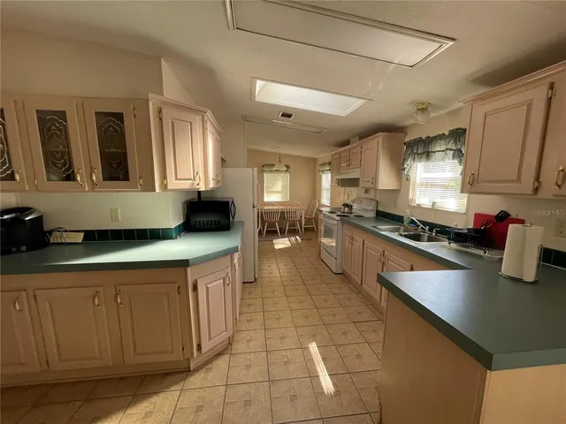 a kitchen with stainless steel appliances granite countertop a sink and cabinets
