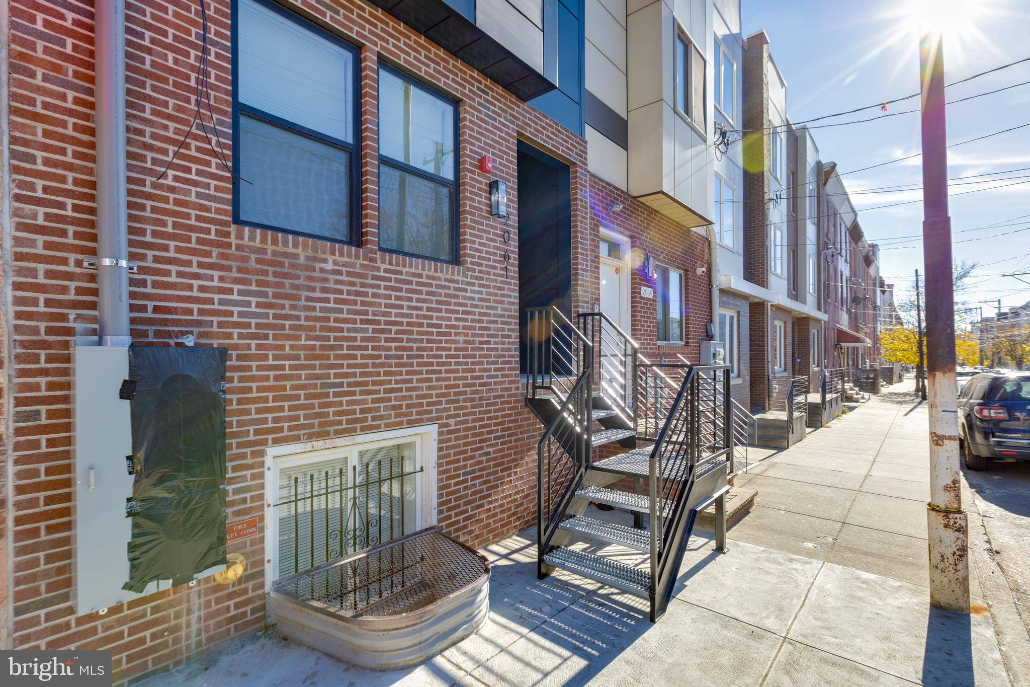 2061 North 8th Street, Unit 3 Philadelphia, PA 19122 - Photo 11 of 11 a view of a brick building with many windows