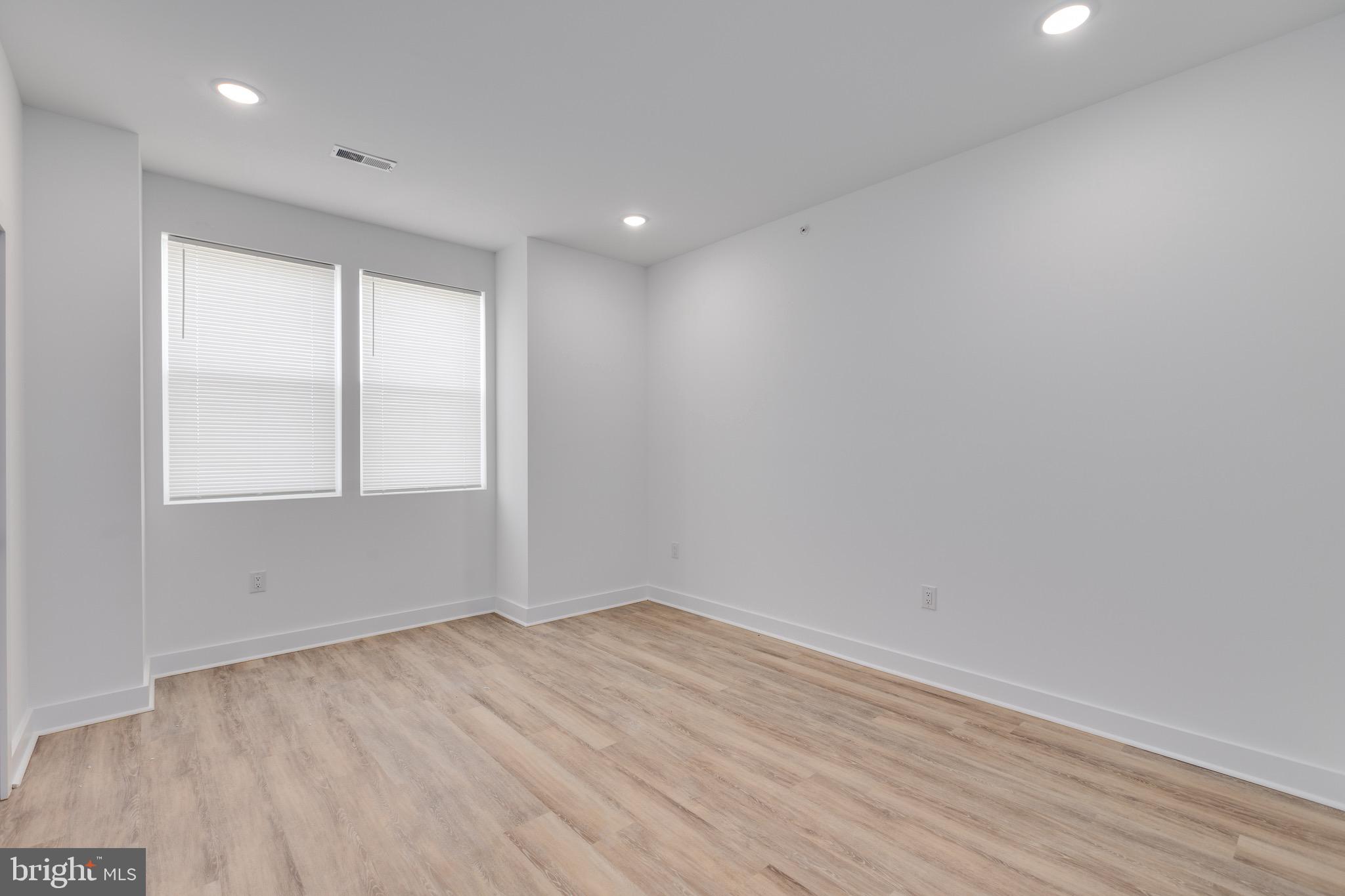 2061 North 8th Street, Unit 3 Philadelphia, PA 19122 - Photo 4 of 11 wooden floor in an empty room with a window