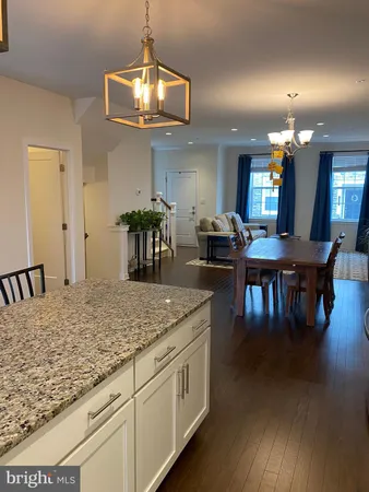 a kitchen with center island table and chairs