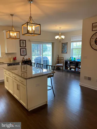 a kitchen with stainless steel appliances granite countertop a stove and a wooden floors