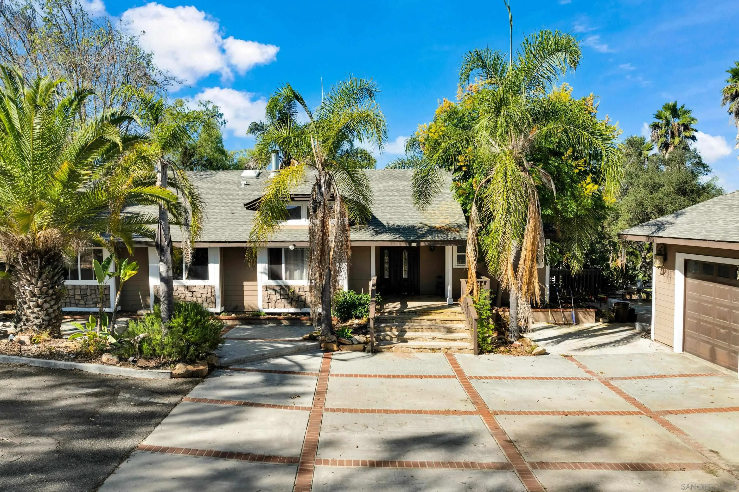 a view of a building with a bench in front of retail shops