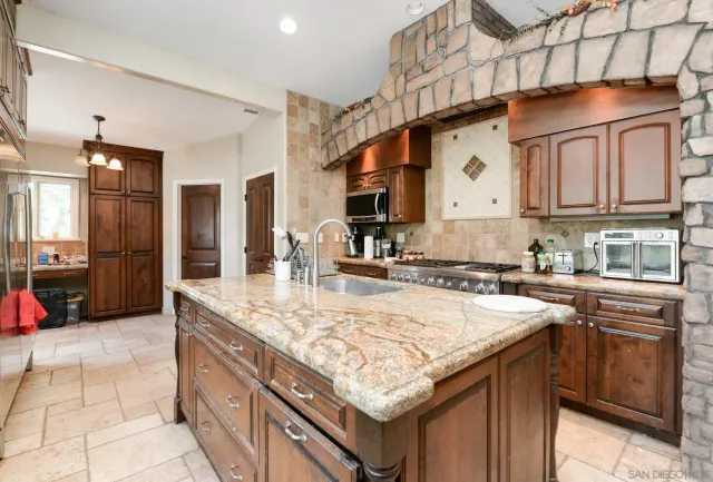 a kitchen with stainless steel appliances granite countertop a sink and cabinets